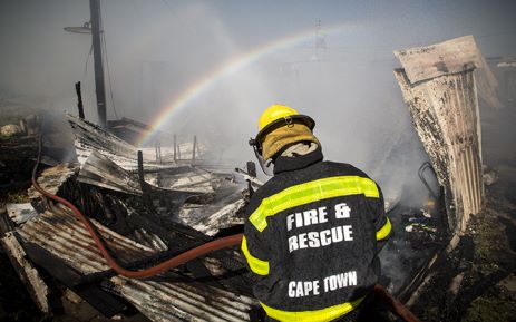 Fire fighters fight a township blaze.